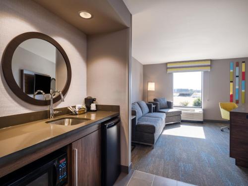 a hotel room with a sink and a living room at Hampton Inn & Suites Boise-Meridian in Meridian