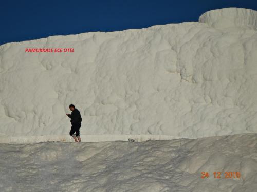 a man standing in front of a large iceberg at Pamukkale Termal Ece Otel in Pamukkale