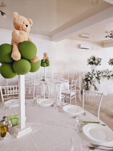 a teddy bear sitting on a pole in a room at CASA Hora in Pîrcovaci