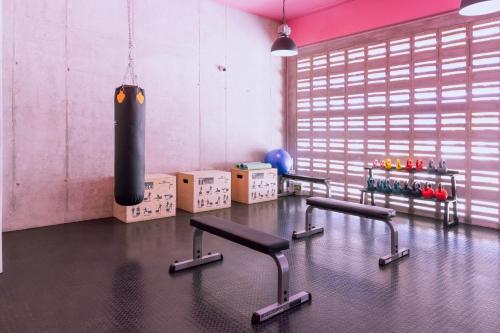 a gym with two chairs and a punching bag at Grotto at 28, City Views and Wonderland Vibes! in Hatillo