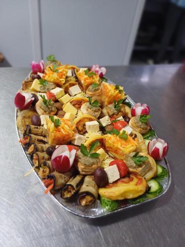 a plate of food on top of a table at CASA Hora in Pîrcovaci