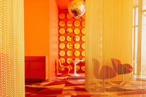 a bathroom with a yellow wall with plates on it at Blue Nun at 29, City Views and Wonderland Vibes! in Hatillo