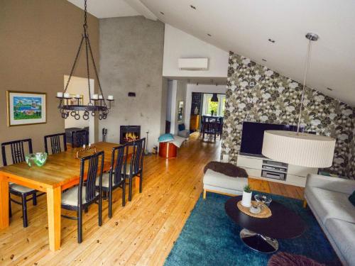 a dining room and living room with a table and chairs at Cosy apartment by the sea-By Traum in Mellbystrand