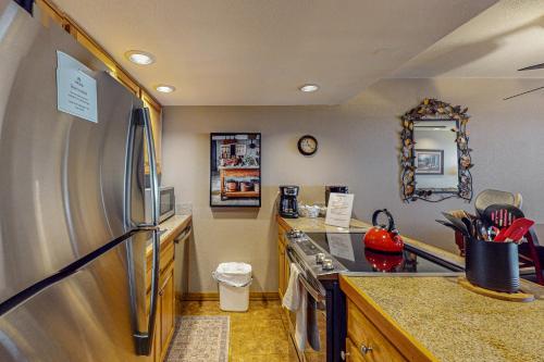 a kitchen with a stainless steel refrigerator at Whispering Pines in Durango Mountain Resort