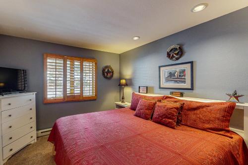 a bedroom with a large bed and a window at Whispering Pines in Durango Mountain Resort