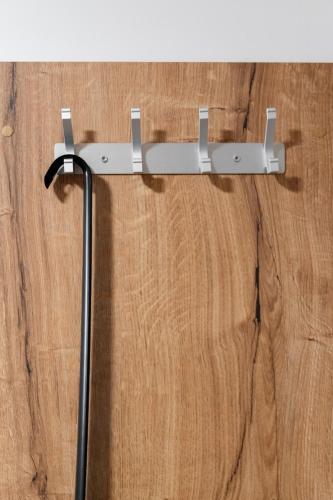 a metal towel rack hanging on a wooden wall at Hiša S'TJE Ljubljana Airport in Cerklje na Gorenjskem