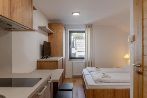 a small room with a bed and a window at Hiša S'TJE Ljubljana Airport in Cerklje na Gorenjskem