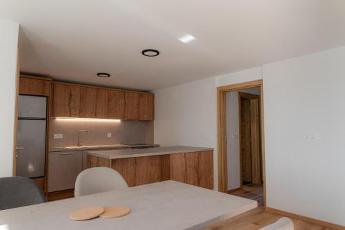 a kitchen with a table and a counter top at Hiša S'TJE Ljubljana Airport in Cerklje na Gorenjskem