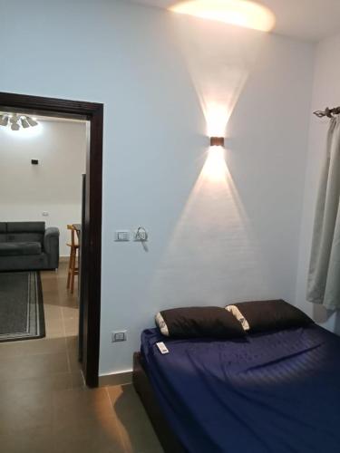 a bedroom with a bed and a light on the wall at Holidays home in Dahab