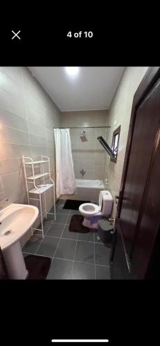 a bathroom with a sink and a toilet and a tub at Holidays home in Dahab