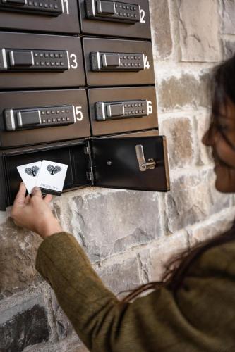 a woman is holding a card in front of a stack ofburning at Jaggling Appartements in Sankt Ulrich am Pillersee