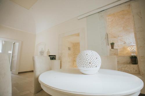 a white bathroom with a white toilet in a room at Dimora Del Vicolo in Ostuni