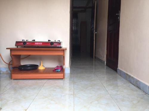 a room with a table and a bowl on a floor at Mary Apartments in Mbale
