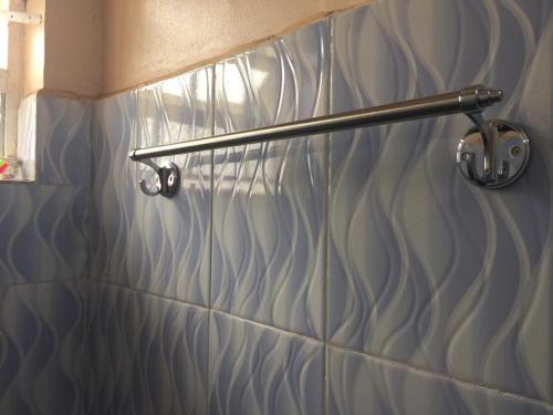 a towel rack on a wall in a bathroom at Mary Apartments in Mbale