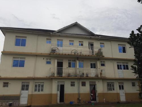 a large building with balconies on the side of it at Mary Apartments in Mbale