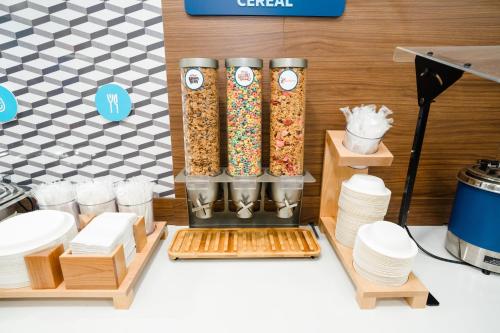 a food stand with a bunch of cereals on a counter at Holiday Inn Express Hotel & Suites Kodak East-Sevierville by IHG in Kodak