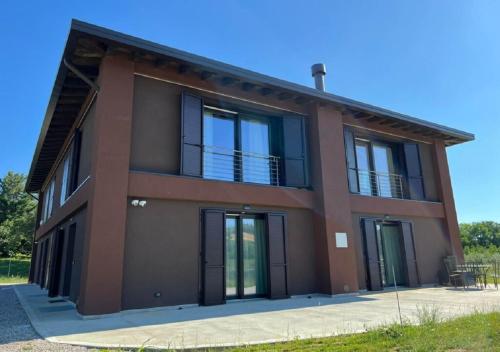 a brown house with black doors and windows at Agriturismo B&B Lombardi Bologna - San Lazzaro in La Mura