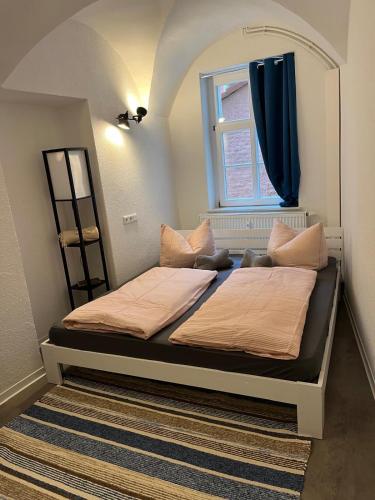 a bedroom with a large bed with a window at Apartment 6 Große Brüdergasse in Bautzen