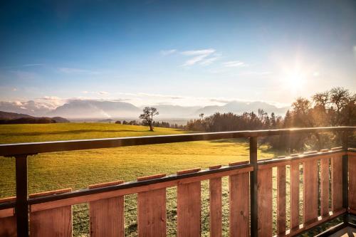 a deck with a view of a field and mountains at Schönbergbauer in Schönberg