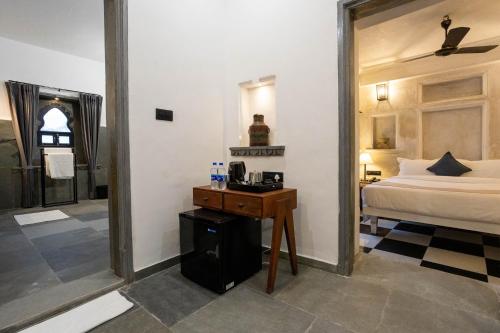a bedroom with a bed and a mirror at Madri Retreat - Heritage Boutique Hotel with Pool in Udaipur