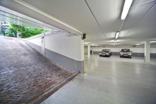 a parking garage with two cars parked in it at Auberge de Smockelaer in Heijenrath