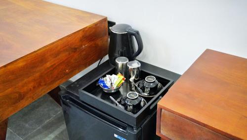a coffee maker sitting on top of a table at Madri Retreat - Heritage Boutique Hotel with Pool in Udaipur