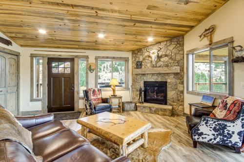 a living room with leather furniture and a stone fireplace at Less Than 1 Mi to Chico Hot Springs Mtn-View Hideaway! in Pray