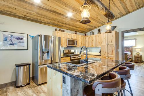a kitchen with wooden cabinets and a stainless steel refrigerator at Less Than 1 Mi to Chico Hot Springs Mtn-View Hideaway! in Pray