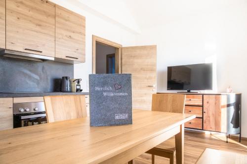 a kitchen with a table with a sign on it at Schönbergbauer in Schönberg