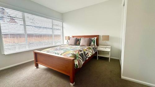 a bedroom with a bed and a window at 34 Jacks Pass Road in Hanmer Springs