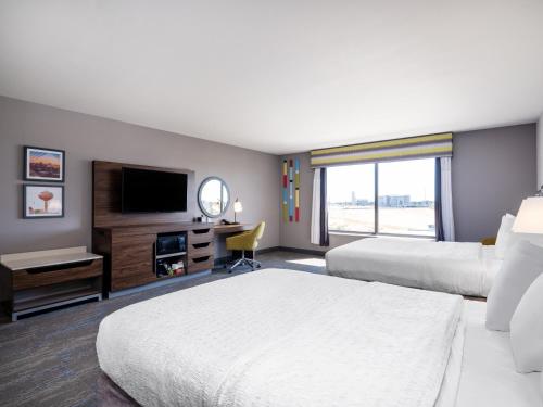 a hotel room with two beds and a television at Hampton Inn & Suites Boise-Meridian in Meridian