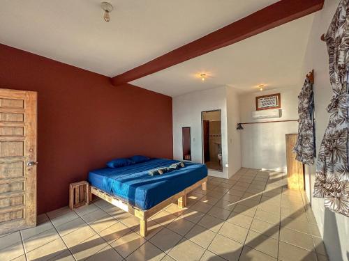 a bedroom with a blue bed in a room at Hotel Manava in Brisas de Zicatela