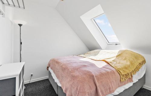 a white bedroom with a bed with a window at Cozy Home In Gudhjem With Wifi in Gudhjem