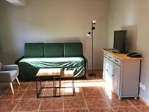 a room with a bed and a desk with a television at Apartaments Bonet in Pal