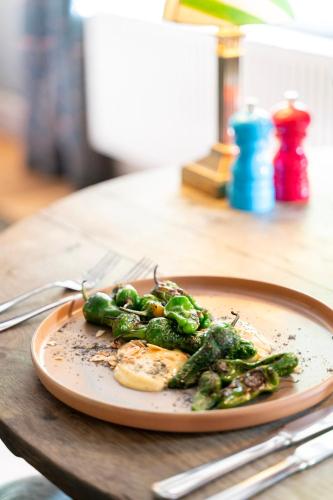 a plate of food with broccoli on a table at Fritton Lake - The Clubhouse in Great Yarmouth