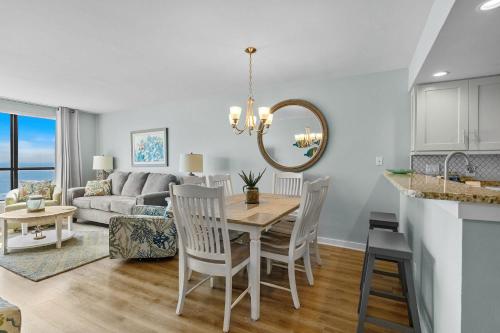 a dining room and living room with a table and chairs at Windemere Beachfront Oasis with Hot Tub and Pool Access in Myrtle Beach