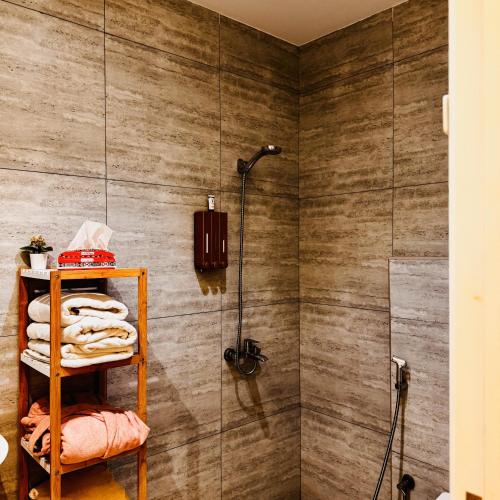 a bathroom with a shower and a shelf with towels at Spacious and Modern Apartment for Rent in Ergah, Riyadh in Riyadh