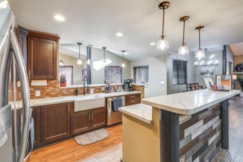 a large kitchen with wooden cabinets and a counter top at Furnished Gazebo with View Rustic Williams Retreat! in Williams