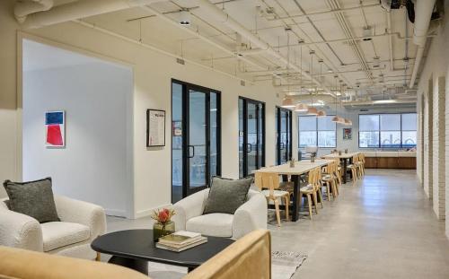a large room with tables and chairs and windows at Luxury Apartments by Hyatus at The Asher in Stamford