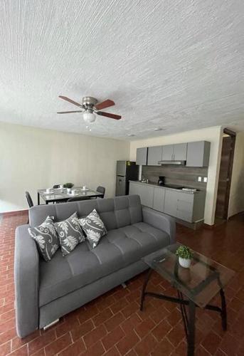 a living room with a couch and a ceiling fan at Morelos 67 Apartment in La Piedad Cavadas