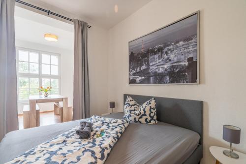 a bedroom with a bed and a television on the wall at großartige Wohnung im Loft-Stil in bester Leipziger Lage in Leipzig