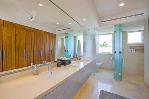 a large bathroom with two sinks and a shower at PH Condo Lago in El Encanto -Lake View Penthouse with Pool Punta Mita in Punta Mita