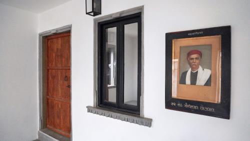 a picture of a man on a wall next to a window at Madri Retreat - Heritage Boutique Hotel with Pool in Udaipur