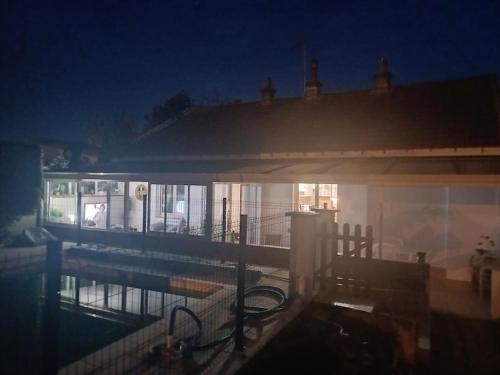 a building with a swimming pool at night at Maison - Moulins 03000 in Moulins
