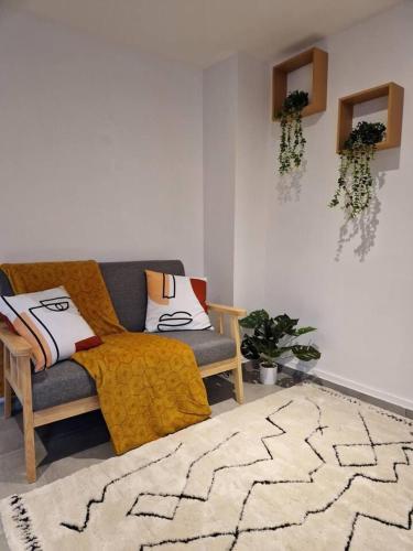 a living room with a couch and a rug at Appartment- Near Train Station - Free Parking in Orléans