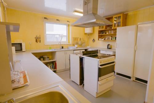 a kitchen with white cabinets and a stove top oven at Getaway house near Arboretum Botanical Garden in Ogre