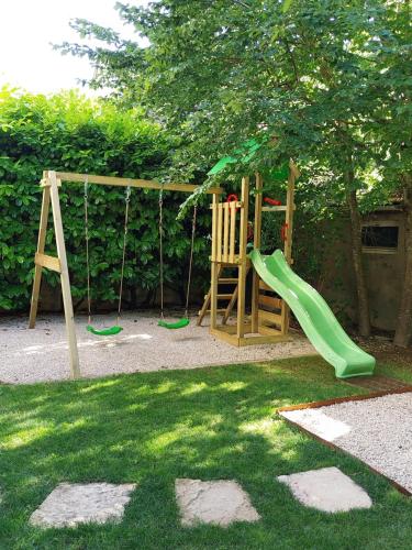 a playground with a slide and a swing at A PAS DE LOUP, Maison de charme sur domaine viticole in Chaux