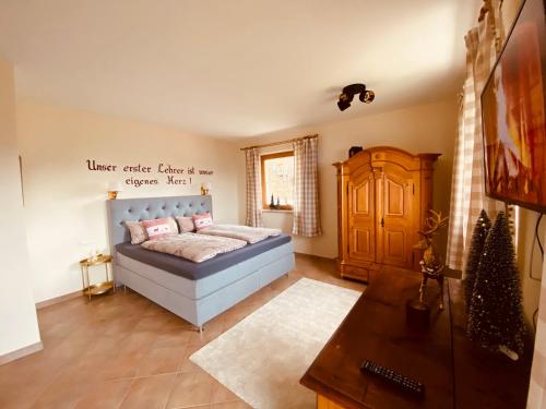 a bedroom with a bed with pink pillows on it at Sonnalm Panoramablick Garten Sauna in Rohrberg