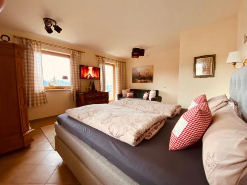 a bedroom with a bed and a couch at Sonnalm Panoramablick Garten Sauna in Rohrberg