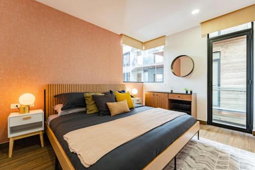 a bedroom with a large bed and a window at Modern Apartment with Gym in La Condesa in Mexico City